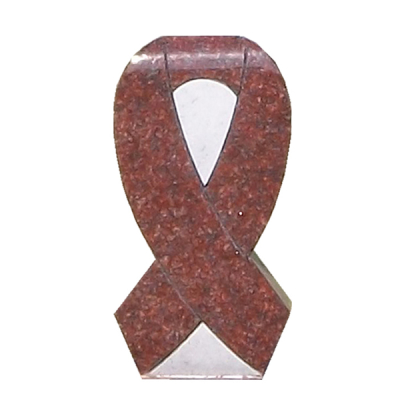 A red granite memorial in the shape of a ribbon, symbolizing awareness or remembrance, with polished detailing.